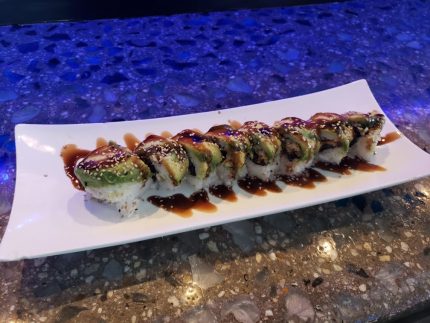 Inside: shrimp, crab meat and cucumber
Outside: avocado drizzled with sweet sauce