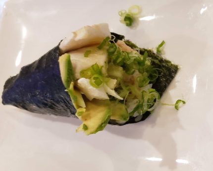 Cooked Chilean Sea Bass, avocado, crab meat, green onions, topped with ponzu sauce, wrapped in seaweed.