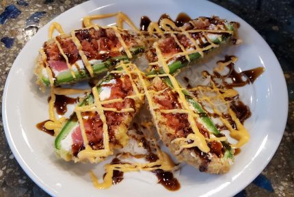 Spicy tuna and cream cheese stuffed in a fresh jalapeno shell; fried in a tempura batter, then cut in half and drizzled with a sweet and spicy sauce.