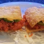 2 pieces of a spicy tuna mix, with avocado inside a crispy wonton shell, topped with a spicy mayo sauce and a sliced jalapeno