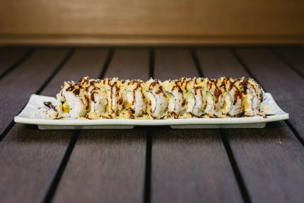 Inside: shrimp tempura, crab meat, avocado and cucumber
Outside: crunch flakes drizzled with sweet sauce