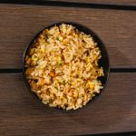 A delicious bowl of fried rice mixed with egg and vegetables