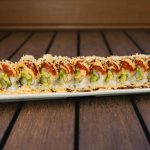 Inside: shrimp tempura and avocado
Outside: spicy tuna drizzled with spicy sauce and crunch flakes