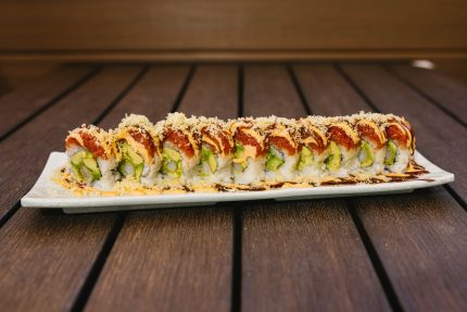 Inside: shrimp tempura and avocado
Outside: spicy tuna drizzled with spicy sauce and crunch flakes