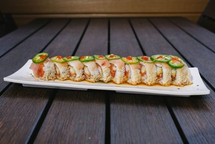 Inside: spicy tuna, shrimp tempura, and cucumber Outside: fresh yellow tail, jalapenos, drizzled with ponzu sauce and a dab of sriracha &nbsp;