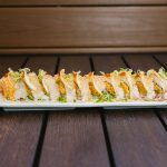 Inside: salmon, spicy crab, avocado
Outside: white fish, thinly sliced lemon, drizzled with ponzu, yuzu, and siracha, then sprinkled with chili powder & green onion