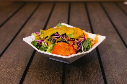 Mixed greens, tomatoes, carrots, cucumbers and sliced avocado.
Each of our salads are served with their very own unique dressings!