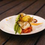 Shrimp tempura, spicy tuna, crab meat, avocado, with spicy sauce and sweet sauce topped with tobico, wrapped in soy paper.