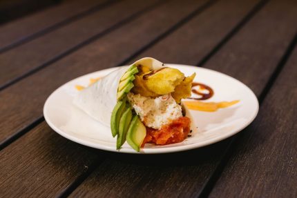 Shrimp tempura, spicy tuna, crab meat, avocado, with spicy sauce and sweet sauce topped with tobico, wrapped in soy paper.