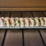 Inside: shrimp tempura, crab meat and cucumber
Outside: shrimp and avocado drizzled with sweet sauce