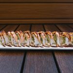 Inside: crab, cucumber and avocado
Outside: baked salmon drizzled with sweet sauce