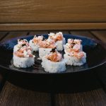 Inside: salmon, crab and avocado
Outside: minced salmon and white onion topped with black tobico