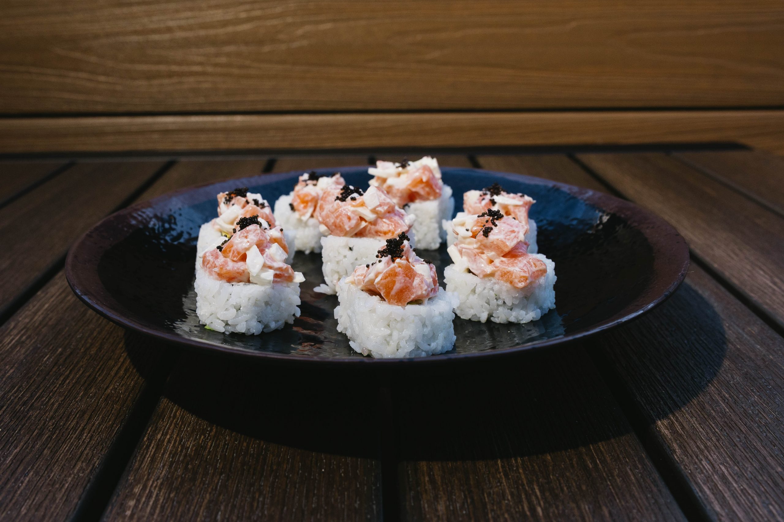 Oh, Canada! Roll Go Fish Sushi Bar - Simi Valley, CA Inside: salmon, crab and avocado
Outside: minced salmon and white onion topped with black tobico
