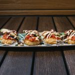 Tempura fried rice ball topped with spicy tuna and avocado drizzled, then drizzled with sweet and spicy sauce