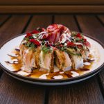Inside: spicy tuna, spicy crab, shrimp tempura
Outside: tuna, albacore, avocado with assorted sauces and tobico, featuring a delicious tuna rose
